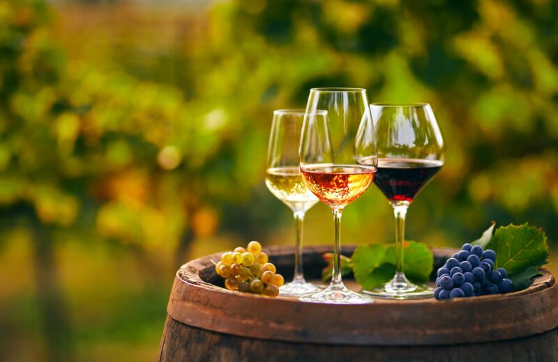 Three,Glasses,With,White,,Rose,And,Red,Wine,On,A